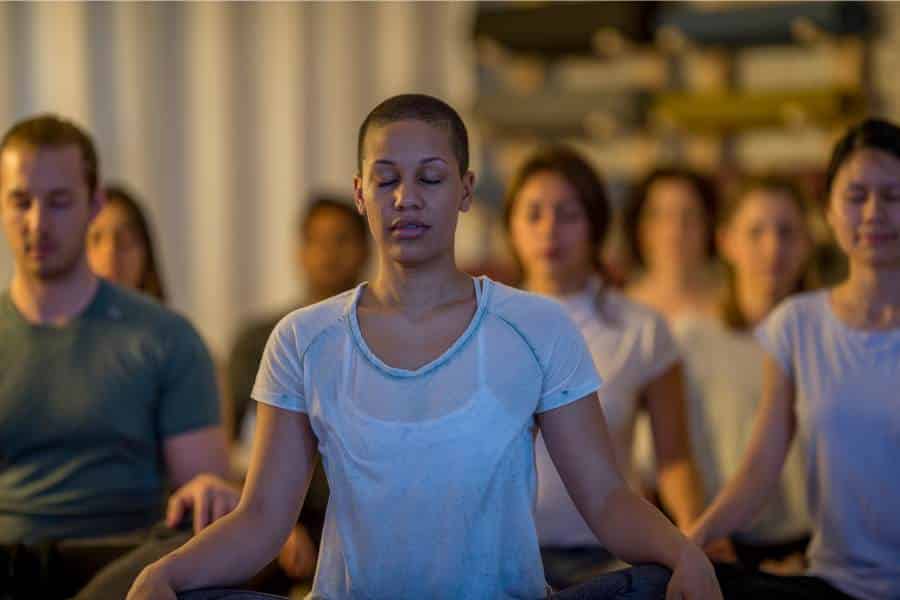 A group of people meditating in a room.