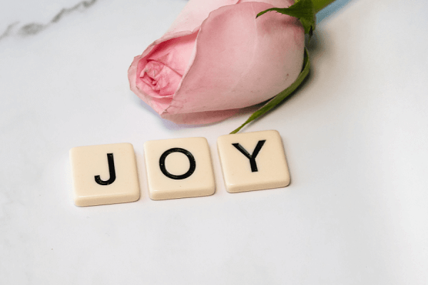 Image of a rose and the word "joy"